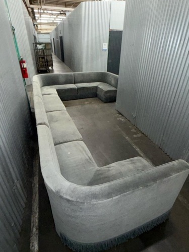 large curved sectional sofa upholstered in gray fabric