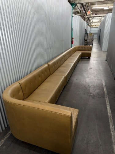 long modular sectional sofa upholstered in mustard/tan leather