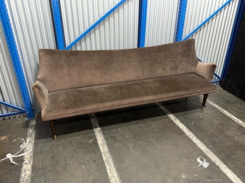 long upholstered bench/sofa with a brown fabric finish
