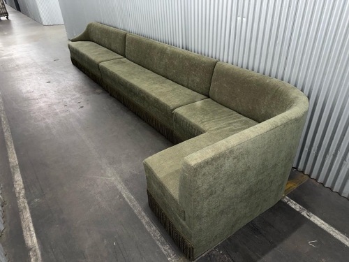 long, curved sectional sofa upholstered in olive green fabric