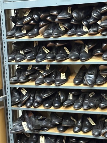 Collection of assorted Men's civilian footwear, on 16 sections of shelving